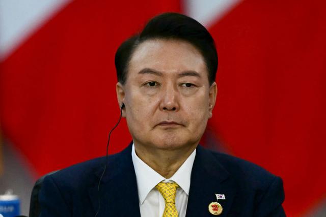 (FILES) South Korea's President Yoon Suk Yeol attends the first day of the G20 Summit in Rio de Janeiro, Brazil, on November 18, 2024. South Korea's highest court on July 9, 2026 upheld ex-president Yoon Suk Yeol's seven year prison sentence over crimes tied to his botched 2024 martial law declaration and its chaotic aftermath. (Photo by Pablo PORCIUNCULA / AFP)