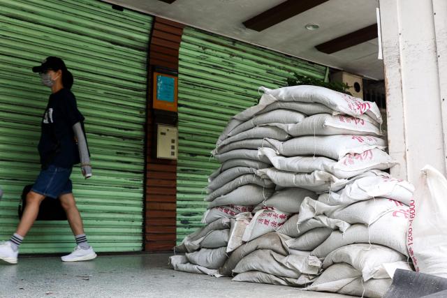 Sandbags are stacked outside a building ahead of the arrival of Typhoon Bavi, in Taipei on July 9, 2026 (Photo by I-Hwa Cheng / AFP)