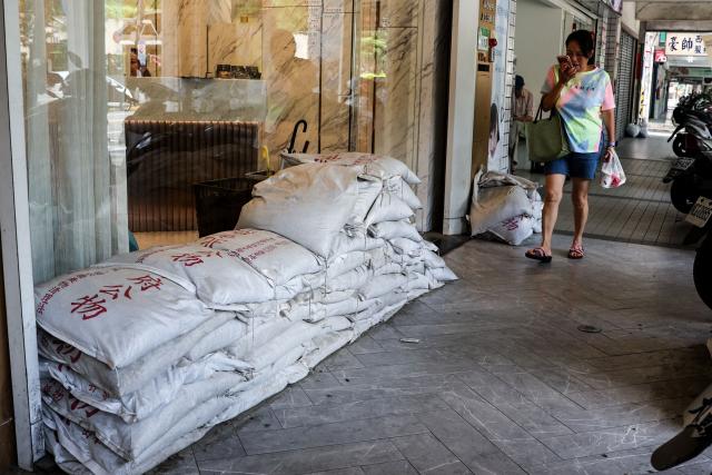 Sandbags are stacked outside a building ahead of the arrival of Typhoon Bavi, in Taipei on July 9, 2026 (Photo by I-Hwa Cheng / AFP)
