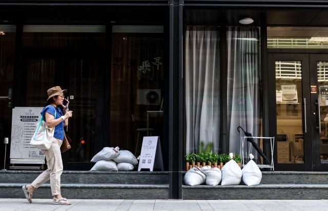 Sandbags are stacked outside a building ahead of the arrival of Typhoon Bavi, in Taipei on July 9, 2026 (Photo by I-Hwa Cheng / AFP)