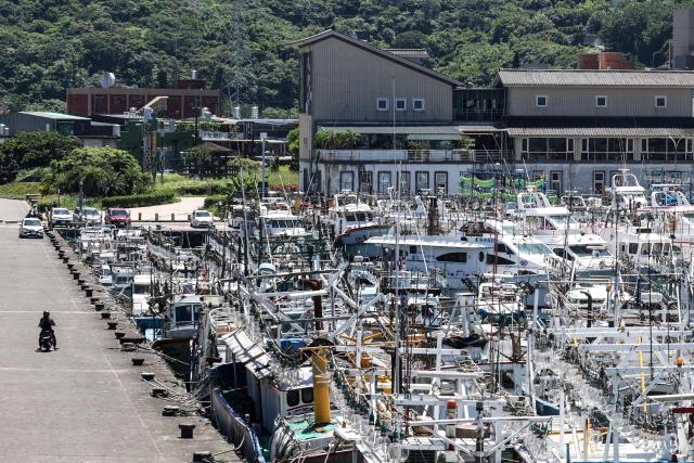 Fishing boats are secured at Shen'ao Harbour ahead of the arrival of Typhoon Bavi, in New Taipei City on July 9, 2026 (Photo by I-Hwa Cheng / AFP)