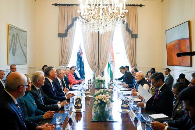 Australia's Prime Minister Anthony Albanese (5th L) and India's Prime Minister Narendra Modi (3rd R), along with other officials, attend the Australia-India Annual Leaders’ Summit at Government House Victoria on July 09, 2026. (Photo by Izhar KHAN / POOL / AFP)