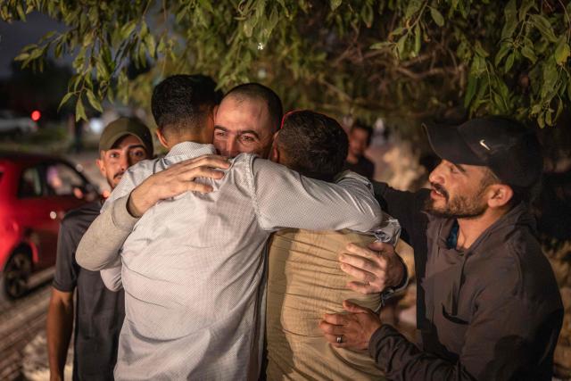Palestinian Rabia Abu Naim (C) hugs his family member following his release from Israeli prison at the checkpoint on the outskirts of Israeli occupied West Bank city of Ramallah on July 8, 2026. The number of Palestinian detainees in Israeli prisons stands at around 9,500, according to figures released in June by the Palestinian Prisoners Club, the main rights group for Palestinian prisoners. Since the start of the Gaza war in October 2023, violence has escalated in the Israeli-occupied West Bank. (Photo by ilia YEFIMOVICH / AFP)