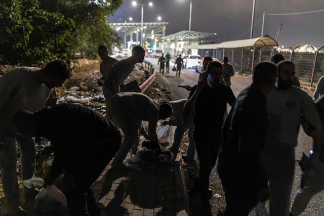 Palestinian prisoners gather their belongings following their release from Israeli prison at the checkpoint on the outskirts of Israeli occupied West Bank city of Ramallah on July 8, 2026. The number of Palestinian detainees in Israeli prisons stands at around 9,500, according to figures released in June by the Palestinian Prisoners Club, the main rights group for Palestinian prisoners. Since the start of the Gaza war in October 2023, violence has escalated in the Israeli-occupied West Bank. (Photo by ilia YEFIMOVICH / AFP)