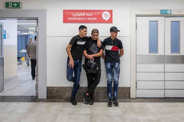 Relatives of Palestinian men who had been released from Israeli prison, wait for their medical examinations at a hospital in Ramallah, in the Israeli-occupied West Bank, on July 8, 2026. The number of Palestinian detainees in Israeli prisons stands at around 9,500, according to figures released in June by the Palestinian Prisoners Club, the main rights group for Palestinian prisoners. Since the start of the Gaza war in October 2023, violence has escalated in the Israeli-occupied West Bank. (Photo by ilia YEFIMOVICH / AFP)