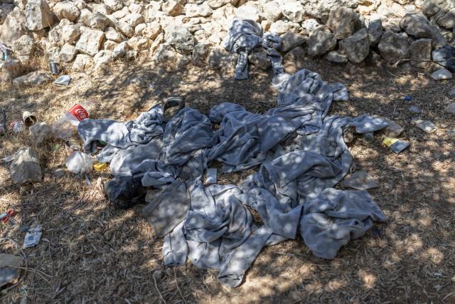 Prison clothes are pictured lying on the ground following the release of Palestinian prisoners from Israeli prison at the checkpoint on the outskirts of Israeli occupied West Bank city of Ramallah on July 8, 2026. The number of Palestinian detainees in Israeli prisons stands at around 9,500, according to figures released in June by the Palestinian Prisoners Club, the main rights group for Palestinian prisoners. Since the start of the Gaza war in October 2023, violence has escalated in the Israeli-occupied West Bank. (Photo by ilia YEFIMOVICH / AFP)