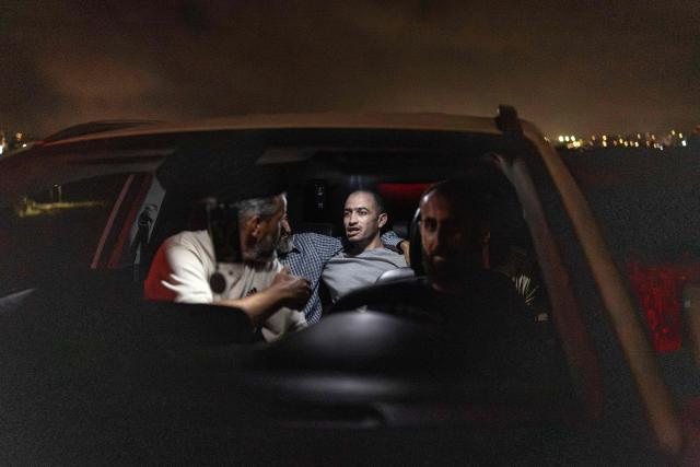 Palestinian Rabia Abu Naim is pictured in the car with his family on the way to the hospital at the checkpoint following his release from Israeli prison on the outskirts of Israeli occupied West Bank city of Ramallah on July 8, 2026. The number of Palestinian detainees in Israeli prisons stands at around 9,500, according to figures released in June by the Palestinian Prisoners Club, the main rights group for Palestinian prisoners. Since the start of the Gaza war in October 2023, violence has escalated in the Israeli-occupied West Bank. (Photo by ilia YEFIMOVICH / AFP)