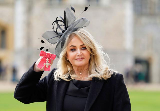 (FILES) British singer Gaynor Sullivan aka Bonnie Tyler poses with her medal after being appointed a Member of the Order of the British Empire (MBE) during an investiture ceremony at Windsor Castle in Windsor, west of London, on February 1, 2023. Welsh singer Bonnie Tyler best known for her powerful, haunting love song "Total Eclipse of the Heart" has died at the age of 75, her family announced on July 9, 2026. (Photo by Andrew Matthews / POOL / AFP)