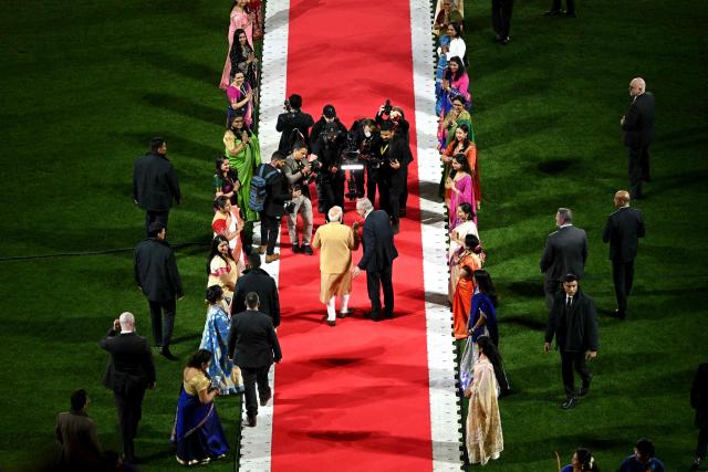 Australia’s Prime Minister Anthony Albanese (centre R) and Indian Prime Minister Narendra Modi (centre L) walk towards the stage during a community event at Docklands Stadium in Melbourne on July 9, 2026. (Photo by WILLIAM WEST / AFP)