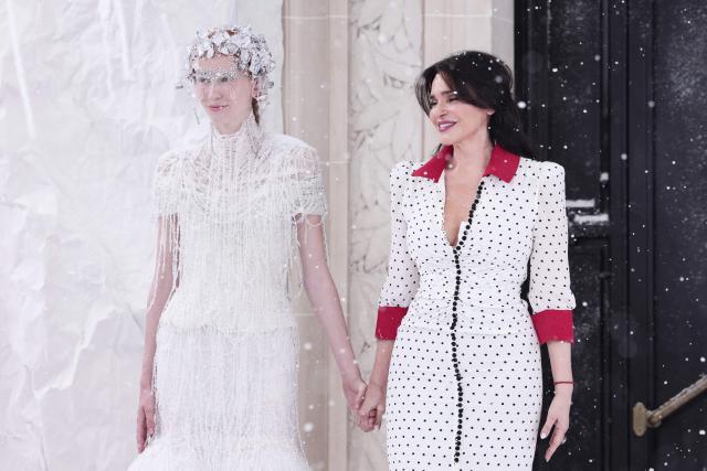 Greek fashion designer Celia Kritharioti (R) acknowledges the audience at the end of the  Celia Kritharioti Women Haute Couture Fall/Winter 2026-2027 collection fashion show as part of the Paris Fashion Week, in Paris, on July 9, 2026. (Photo by Behrouz MEHRI / AFP)