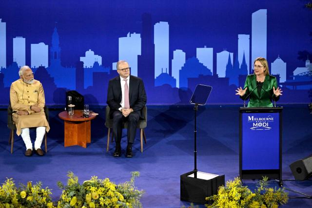 Australia’s Prime Minister Anthony Albanese (C) listens with Indian Prime Minister Narendra Modi (L) to Victorian Premier Jacinta Allan (R) as she speaks during a community event at Docklands Stadium in Melbourne on July 9, 2026. (Photo by WILLIAM WEST / AFP)