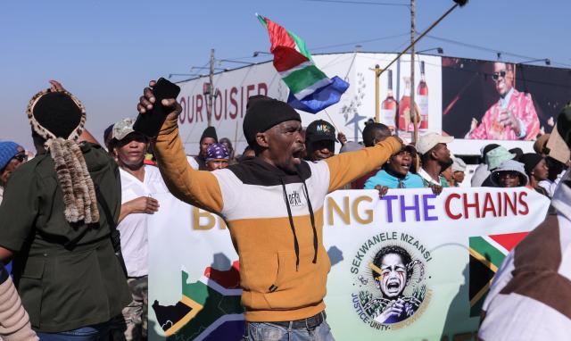 Protesters gather during an anti immigrant march to the Diepkloof police station in Soweto, on July 9, 2026. (Photo by Mzingenkosi Sibanda / AFP)