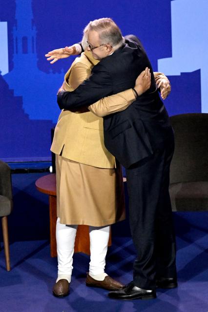 Australia’s Prime Minister Anthony Albanese (R) and Indian Prime Minister Narendra Modi hug on stage during a community event at Docklands Stadium in Melbourne on July 9, 2026. (Photo by WILLIAM WEST / AFP)