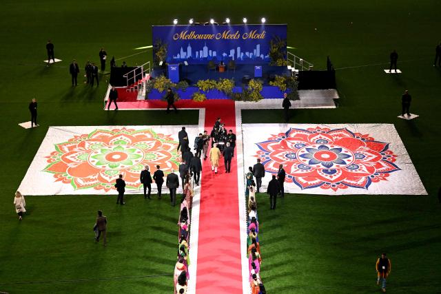 Australia’s Prime Minister Anthony Albanese (centre R) walks with Indian Prime Minister Narendra Modi (centre L) towards a stage during a community event at Docklands Stadium in Melbourne on July 9, 2026. (Photo by WILLIAM WEST / AFP)