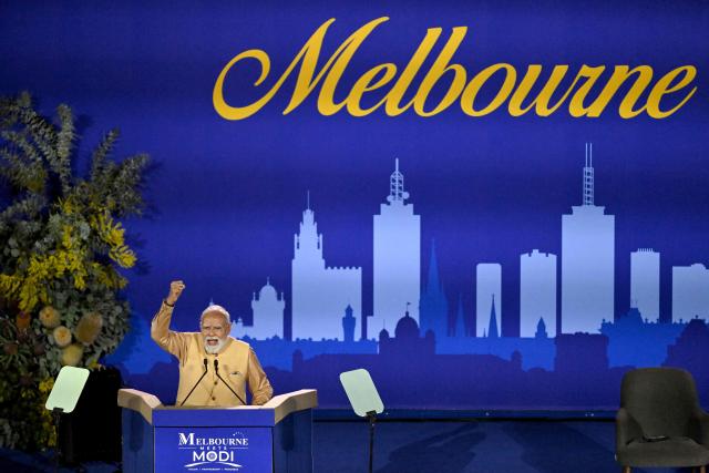 Indian Prime Minister Narendra Modi reacts as he speaks on a stage during a community event at Docklands Stadium in Melbourne on July 9, 2026. (Photo by WILLIAM WEST / AFP)