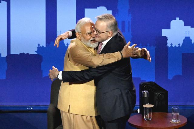 Australia’s Prime Minister Anthony Albanese (R) hugs Indian Prime Minister Narendra Modi as they stand on stage during a community event at Docklands Stadium in Melbourne on July 9, 2026. (Photo by WILLIAM WEST / AFP)