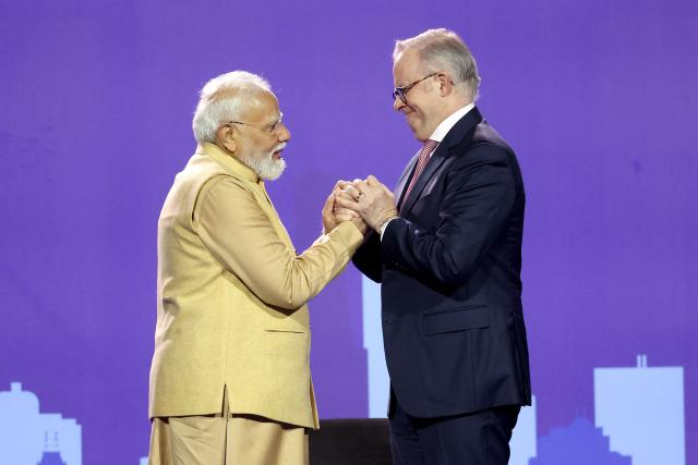 Australia’s Prime Minister Anthony Albanese (R) reacts with Indian Prime Minister Narendra Modi during a community event at Docklands Stadium in Melbourne on July 9, 2026. (Photo by MARTIN KEEP / AFP)
