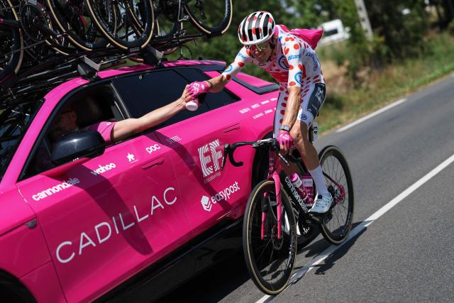 EF Education - EasyPost team's French rider Alex Baudin wearing the climber's dotted "King of the Mountains" jersey collects hydration bottles at his team vehicle as he cycles during the 6th stage of the 113th edition of the Tour de France cycling race, 186,2 km between Pau and Gavarnie-Gèdre in the French Pyrenees, on July 9, 2026. (Photo by Anne-Christine POUJOULAT / AFP)