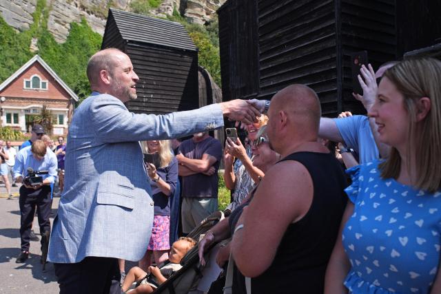 Britain's Prince William, Prince of Wales (L) meets well-wishers during his visit to Hastings, south-east England on July 9, 2026, to highlight the town's fishing community and the vital work of local youth-led and community-driven organisations. (Photo by Gareth Fuller / POOL / AFP)