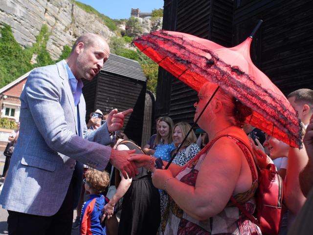 Britain's Prince William, Prince of Wales (L) meets well-wishers during his visit to Hastings, south-east England on July 9, 2026, to highlight the town's fishing community and the vital work of local youth-led and community-driven organisations. (Photo by Gareth Fuller / POOL / AFP)