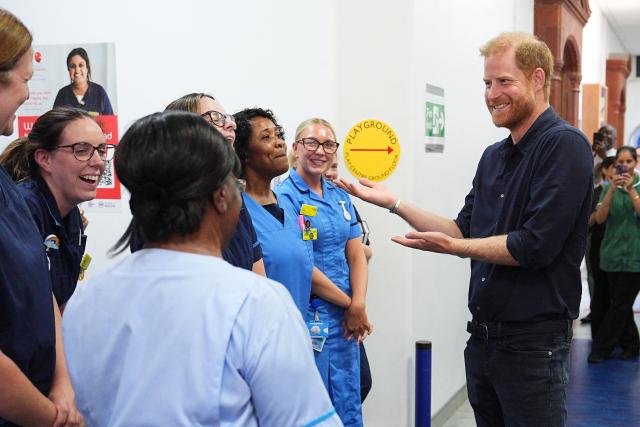 Britain's Prince Harry, Duke of Sussex (R), chats with nursing staff during a visit to Birmingham Children’s Hospital in the city of Birmingham, central England, on July 9, 2026, to celebrate the 20th anniversary of the very first WellChild Nurse. Created in 2006, the role of the WellChild Nurse is part funded by Prince Harry, and was designed to support children with complex medical needs and their families. (Photo by Aaron Chown / POOL / AFP)