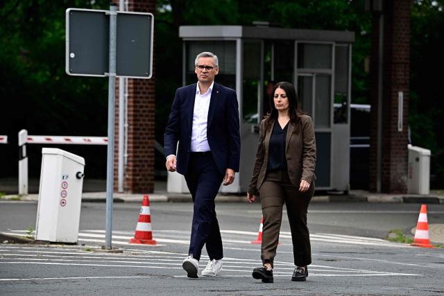 Daniela Cavallo (R), chairwoman of the central works council of German car maker Volkswagen (VW) and Thorsten Groeger of German trade union IG Metall arrive to addresses journalists at a rally to protest against restructuring and mass job cut plans at the VW headquarters on July 9, 2026 at the Wolfsburg Volkswagen Plant in Wolfsburg, northern Germany. IG Metall is organising protests by VW workers outside plants across the country on July 9, when the carmaker's bosses will present the restructuring plans to the supervisory board. Europe's largest carmaker has come under intense pressure from US tariffs, slimmer profit margins from electric cars and above all intense competition in China, the world's largest auto market. VW, whose 10 brands range from mass-market Seats to premium Porsches, is already in the process of axing 50,000 jobs in Germany by 2030, including 35,000 at its namesake marque. (Photo by Tobias SCHWARZ / AFP)