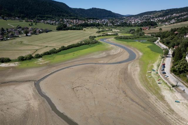 This aerial photograph shows the dry riverbed of the Doubs river on July 9, 2026, in Villers-le-Lac, eastern France. (Photo by SEBASTIEN BOZON / AFP)