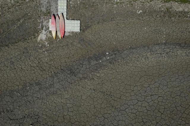 TOPSHOT - This aerial photograph shows the dry riverbed of the Doubs river on July 9, 2026, in Villers-le-Lac, eastern France. (Photo by SEBASTIEN BOZON / AFP)