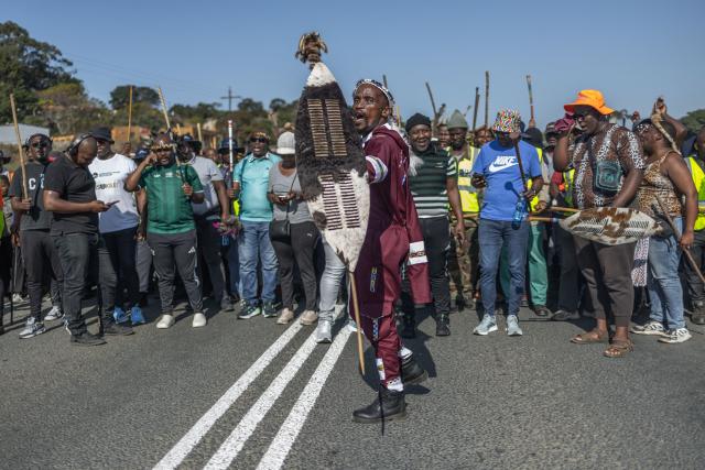 TOPSHOT - Protestors with traditional attire chant slogans during a demonstration by the "March and March" movement in Mtwalume, south of Durban, on July 9, 2026. The group previously held nationwide marches on June 30, 2026, and has called on its supporters to continue demonstrating every Thursday. The movement is calling on the government to enforce tougher measures against illegal immigration and to deport undocumented foreign nationals. The protests comes amid broader national discussions on border security, law enforcement, economic pressures, and South Africa's approach to immigration. (Photo by RAJESH JANTILAL / AFP)