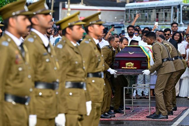 Officers carry the coffin of prison jailer S.H.G. Chandrawansha, killed in Negombo prison riot, during his funeral ceremony in Colombo on July 9, 2026. Sri Lanka launched an investigation on July 7 into its deadliest prison riot in years, as the death toll from clashes between rival drug gangs rose to 27. (Photo by Ishara S. KODIKARA / AFP)