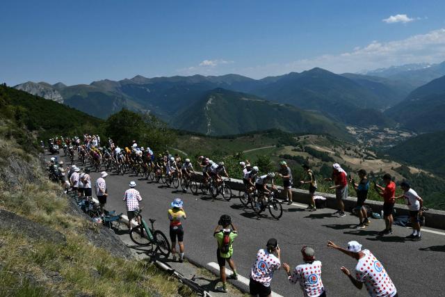 The pack of riders (peloton) cycle in the Col d'Aspin ascent during the 6th stage of the 113th edition of the Tour de France cycling race, 186,2 km between Pau and Gavarnie-Gèdre in the French Pyrenees, on July 9, 2026. (Photo by Jeff PACHOUD / AFP)