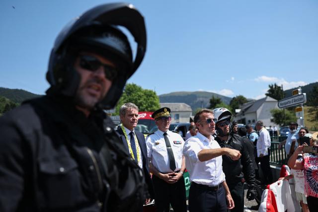 France's President Emmanuel Macron gestures as he arrives to attend a portion of the 6th stage of the 113th edition of the Tour de France cycling race, 186,2 km between Pau and Gavarnie-Gèdre in the French Pyrenees, on July 9, 2026. (Photo by Anne-Christine POUJOULAT / AFP)