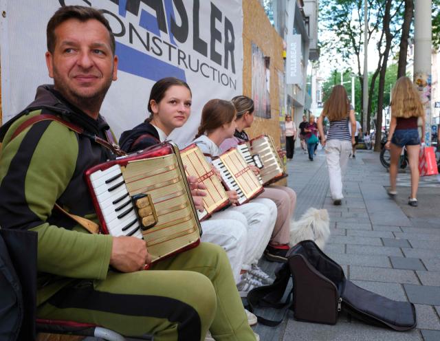 A family from Cracow Poland play accordion at Mariahilfer street in Vienna, Austria, on July 09, 2026. (Photo by Joe KLAMAR / AFP)