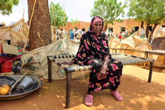 A Sudanese woman poses for a picture at the al-Rahmaniya camp for displaced people near the city of El-Obeid in the southern Kordofan region on July 9, 2026. El-Obeid, a city of half a million people that hosts nearly 100,000 refugees displaced by violence elsewhere, has, in recent weeks, faced its most intense attacks yet from the paramilitary Rapid Support Forces (RSF). After breaking a prolonged siege in February last year, the army has struggled to stop the RSF from reimposing a blockade through repeated drone strikes targeting the city, its infrastructure and the main highway out. (Photo by AFP)