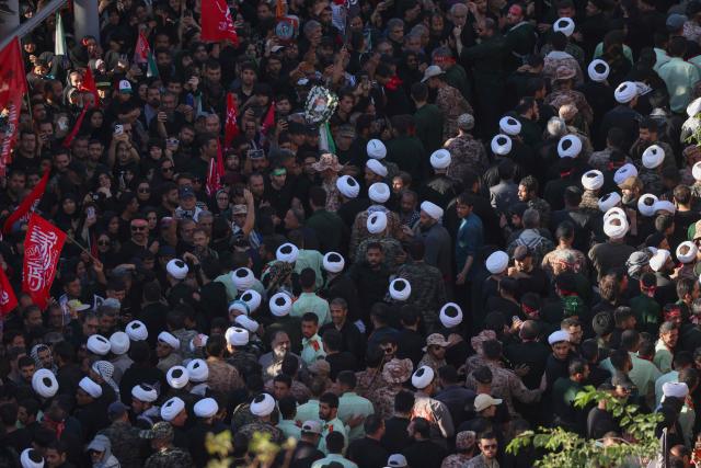 Crowds of mourners attend a funeral procession for Iran's slain supreme leader Ali Khamenei and members of his family, before he is buried at the Shrine of Imam Reza, Iran's most revered place of worship, in Mashhad on July 9, 2026. Braving sweltering heat and calling for revenge, Iranians loyal to the Islamic republic massed on July 9 for the burial of slain supreme leader Ali Khamenei in his hometown of Mashhad. (Photo by ATTA KENARE / AFP) / 
