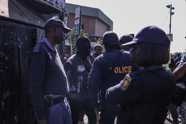 Protesters are stopped by South African police officers during an anti immigrant march in Alexandra, on July 9, 2026. (Photo by MZINGENKOSI SIBANDA / AFP)
