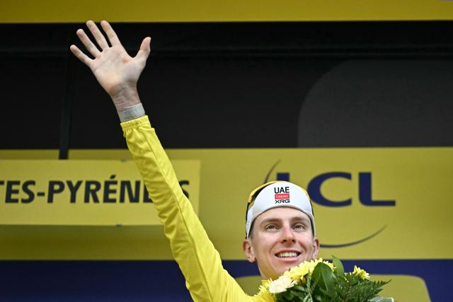 UAE Team Emirates - XRG's Slovenian rider Tadej Pogacar celebrates on the podium with the overall leader's yellow jersey after the 6th stage of the 113th edition of the Tour de France cycling race, 186 km between Pau and Gavarnie-Gèdre in the French Pyrenees, on July 9, 2026. (Photo by Loic VENANCE / AFP)
