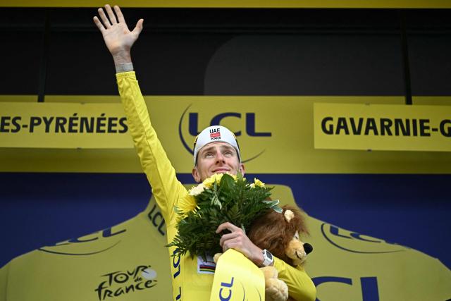 UAE Team Emirates - XRG's Slovenian rider Tadej Pogacar celebrates on the podium with the overall leader's yellow jersey after the 6th stage of the 113th edition of the Tour de France cycling race, 186 km between Pau and Gavarnie-Gèdre in the French Pyrenees, on July 9, 2026. (Photo by Loic VENANCE / AFP)