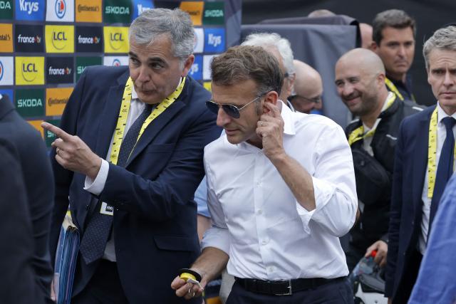 France's President Emmanuel Macron stands in the finish area of the 6th stage of the 113th edition of the Tour de France cycling race, 186 km between Pau and Gavarnie-Gèdre in the French Pyrenees, on July 9, 2026. (Photo by GUILLAUME HORCAJUELO / POOL / AFP)