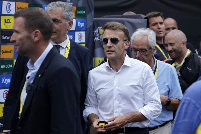 France's President Emmanuel Macron stands in the finish area of the 6th stage of the 113th edition of the Tour de France cycling race, 186 km between Pau and Gavarnie-Gèdre in the French Pyrenees, on July 9, 2026. (Photo by GUILLAUME HORCAJUELO / POOL / AFP)