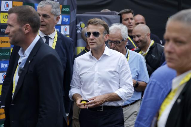 France's President Emmanuel Macron stands in the finish area of the 6th stage of the 113th edition of the Tour de France cycling race, 186 km between Pau and Gavarnie-Gèdre in the French Pyrenees, on July 9, 2026. (Photo by GUILLAUME HORCAJUELO / POOL / AFP)