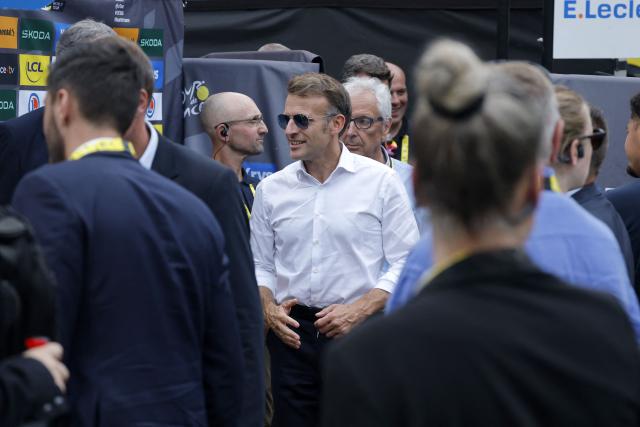 France's President Emmanuel Macron stands in the finish area of the 6th stage of the 113th edition of the Tour de France cycling race, 186 km between Pau and Gavarnie-Gèdre in the French Pyrenees, on July 9, 2026. (Photo by GUILLAUME HORCAJUELO / POOL / AFP)