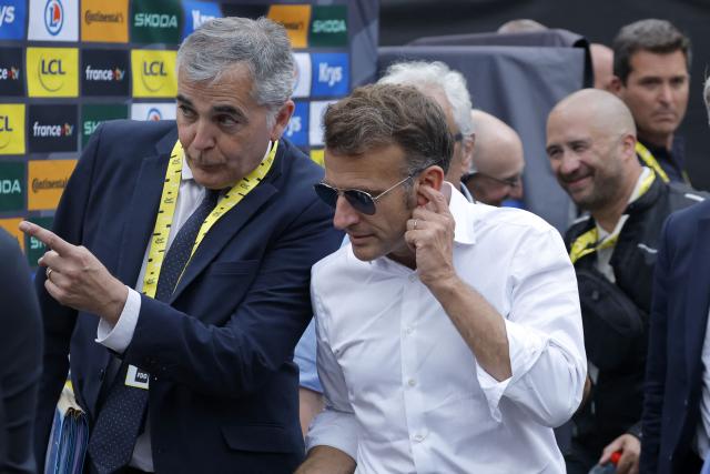 France's President Emmanuel Macron stands in the finish area of the 6th stage of the 113th edition of the Tour de France cycling race, 186 km between Pau and Gavarnie-Gèdre in the French Pyrenees, on July 9, 2026. (Photo by GUILLAUME HORCAJUELO / POOL / AFP)
