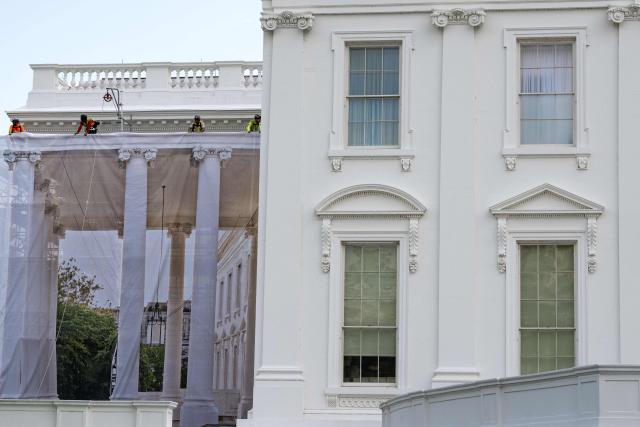 Workers place a protective cover over scaffolding surrounding the North Portico of the White House in Washington, DC on July 9, 2026. (Photo by Kent Nishimura / AFP)