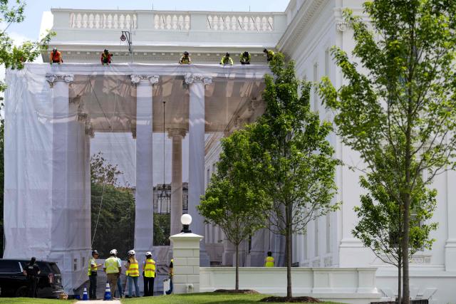 Workers place a protective cover over scaffolding surrounding the North Portico of the White House in Washington, DC on July 9, 2026. (Photo by Kent Nishimura / AFP)