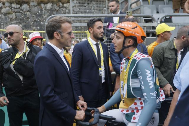 France's President Emmanuel Macron speaks with Netcompany INEOS team's French rider Kevin Vauquelin at the finish are of the 6th stage of the 113th edition of the Tour de France cycling race, 186 km between Pau and Gavarnie-Gèdre in the French Pyrenees, on July 9, 2026. (Photo by Guillaume HORCAJUELO / POOL / AFP)