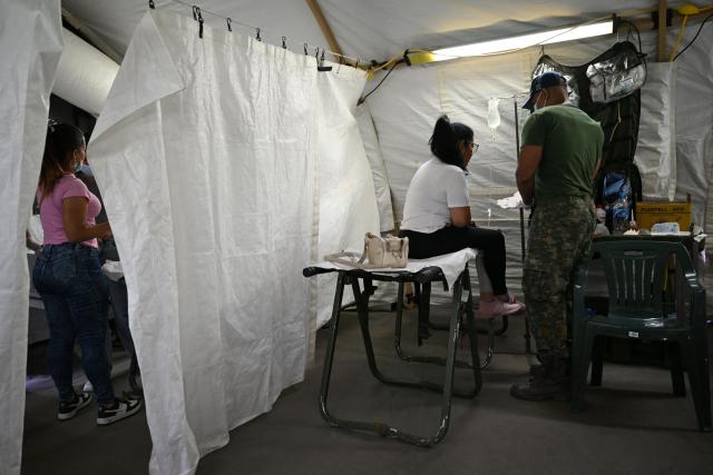 A woman receives medical attention at Brazil's military field hospital in Camuri Chico, near Macuto, La Guaira State, Venezuela on July 9, 2026, following the June 24 twin earthquakes. The United Nations launched an urgent appeal on July 8, 2026 for nearly $300 million towards Venezuela earthquake relief operations as the death toll from the disaster rose to more than 3,800 people. (Photo by Raul ARBOLEDA / AFP)