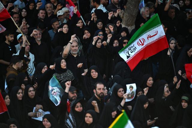 Crowds of mourners gather on a street ahead of the funeral procession of Iran's slain supreme leader Ali Khamenei and members of his family, before he is buried at the Shrine of Imam Reza, Iran's most revered place of worship, in Mashhad on July 9, 2026. Calling for revenge and rejecting any compromise with the West, Iranians loyal to the Islamic republic braved sweltering heat on July 9 to mass for the burial of supreme leader Ali Khamenei in his hometown of Mashhad. (Photo by Wakil Kohsar / AFP) / 