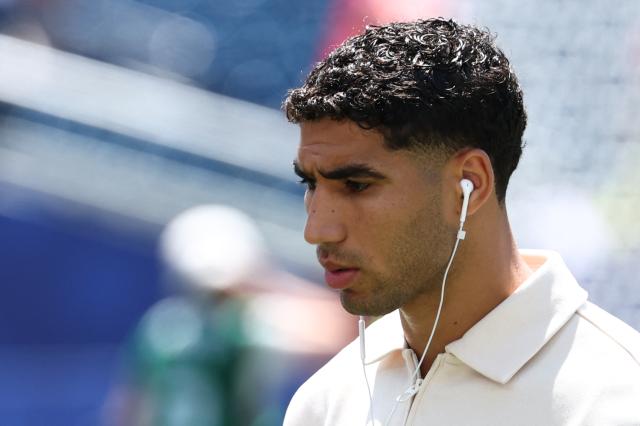 Morocco's defender #02 Achraf Hakimi walks on the pitch ahead of the 2026 World Cup football tournament quarter-final match between France and Morocco at Boston Stadium in Foxborough on July 9, 2026.  (Photo by FRANCK FIFE / AFP)