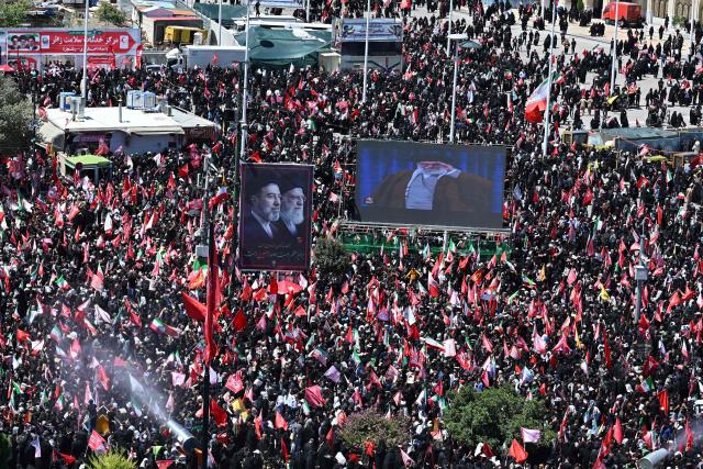 Crowds of mourners gather on a street ahead of the funeral procession of Iran's slain supreme leader Ali Khamenei and members of his family, before he is buried at the Shrine of Imam Reza, Iran's most revered place of worship, in Mashhad on July 9, 2026. Calling for revenge and rejecting any compromise with the West, Iranians loyal to the Islamic republic braved sweltering heat on July 9 to mass for the burial of supreme leader Ali Khamenei in his hometown of Mashhad. (Photo by Wakil Kohsar / AFP) / 